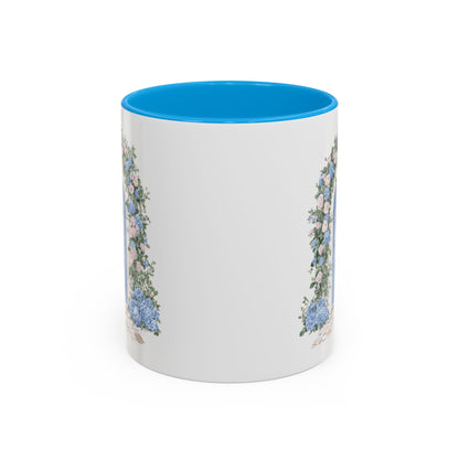 White ceramic mug with blue interior and handle, featuring a watercolor cottage doorway with hydrangeas.