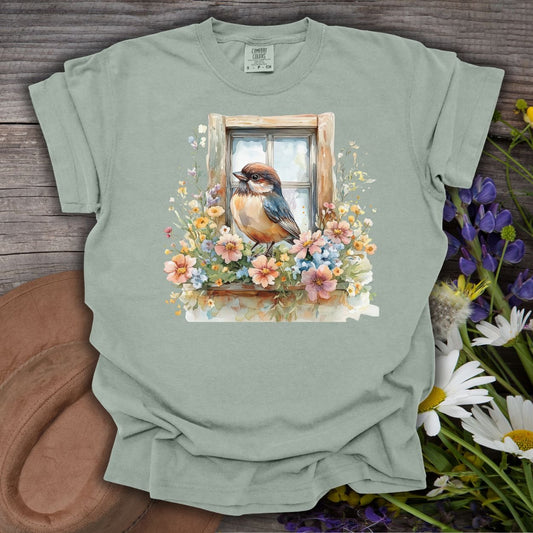 Bay S cottagecore t-shirt with a watercolor bluebird on a floral windowsill design.