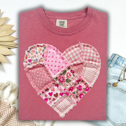 Brick red garment-dyed cotton t-shirt with a cottagecore faux patchwork heart in pinks and cream.