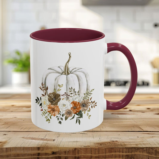 Cottagecore 11 oz glossy ceramic mug with white pumpkin and autumn floral design, maroon handle and interior.