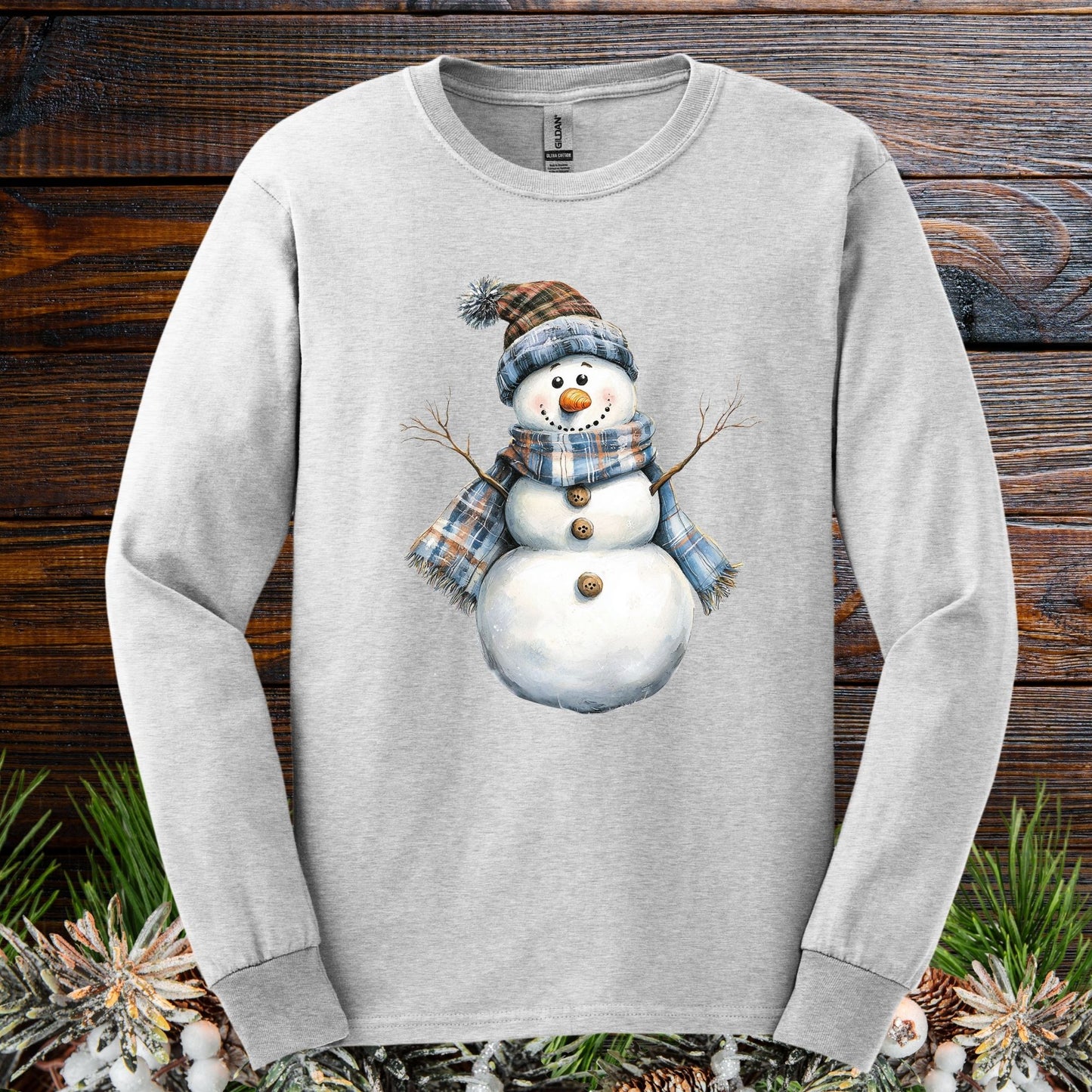 Ash long-sleeve tee with a country snowman in a blue and tan plaid scarf and hat.
