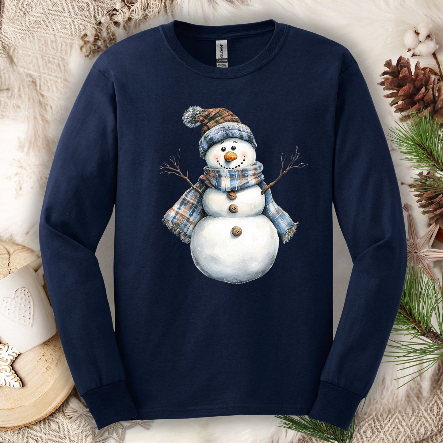 Navy long sleeve tee with a cute snowman wearing a blue and tan plaid scarf and hat.