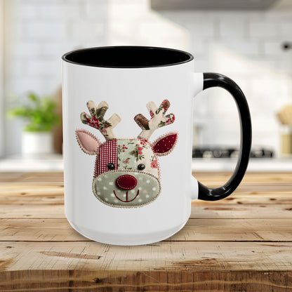 White ceramic mug with black handle and interior, featuring a patchwork Rudolph reindeer design.