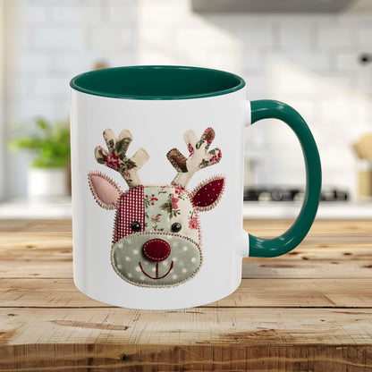 11oz ceramic mug with a patchwork Rudolph design, green interior and handle, on a wooden counter.