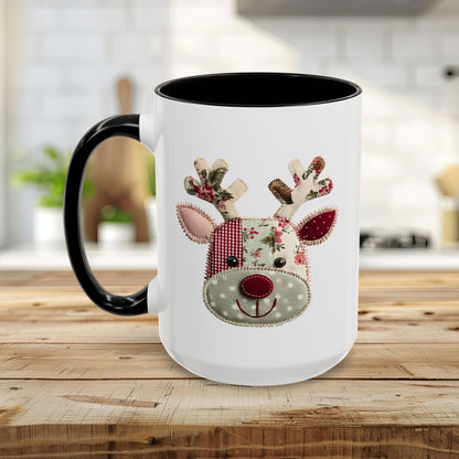 White ceramic mug with black handle and interior, featuring a patchwork Rudolph reindeer design.