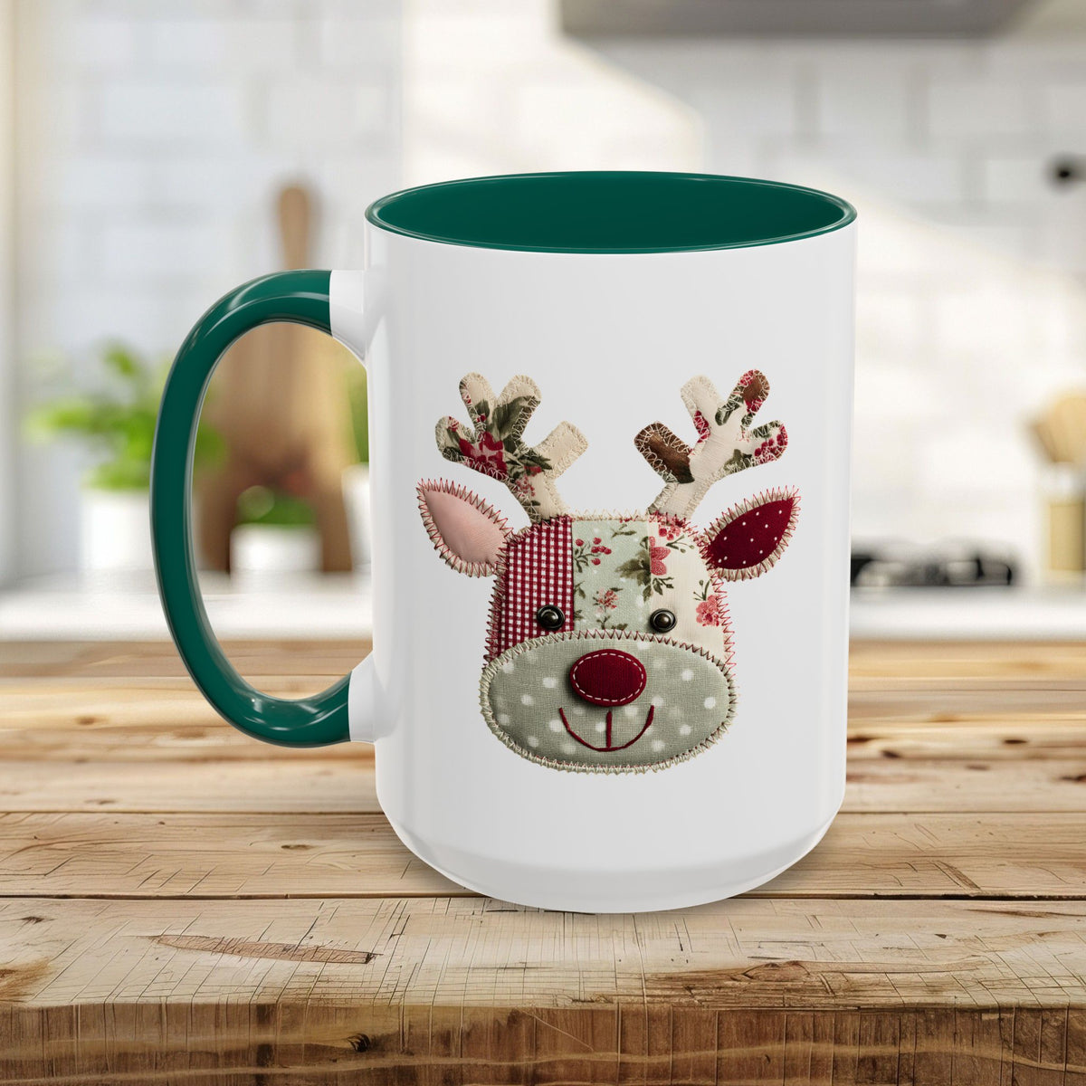 White ceramic mug with green handle and interior, featuring a patchwork Rudolph reindeer design.