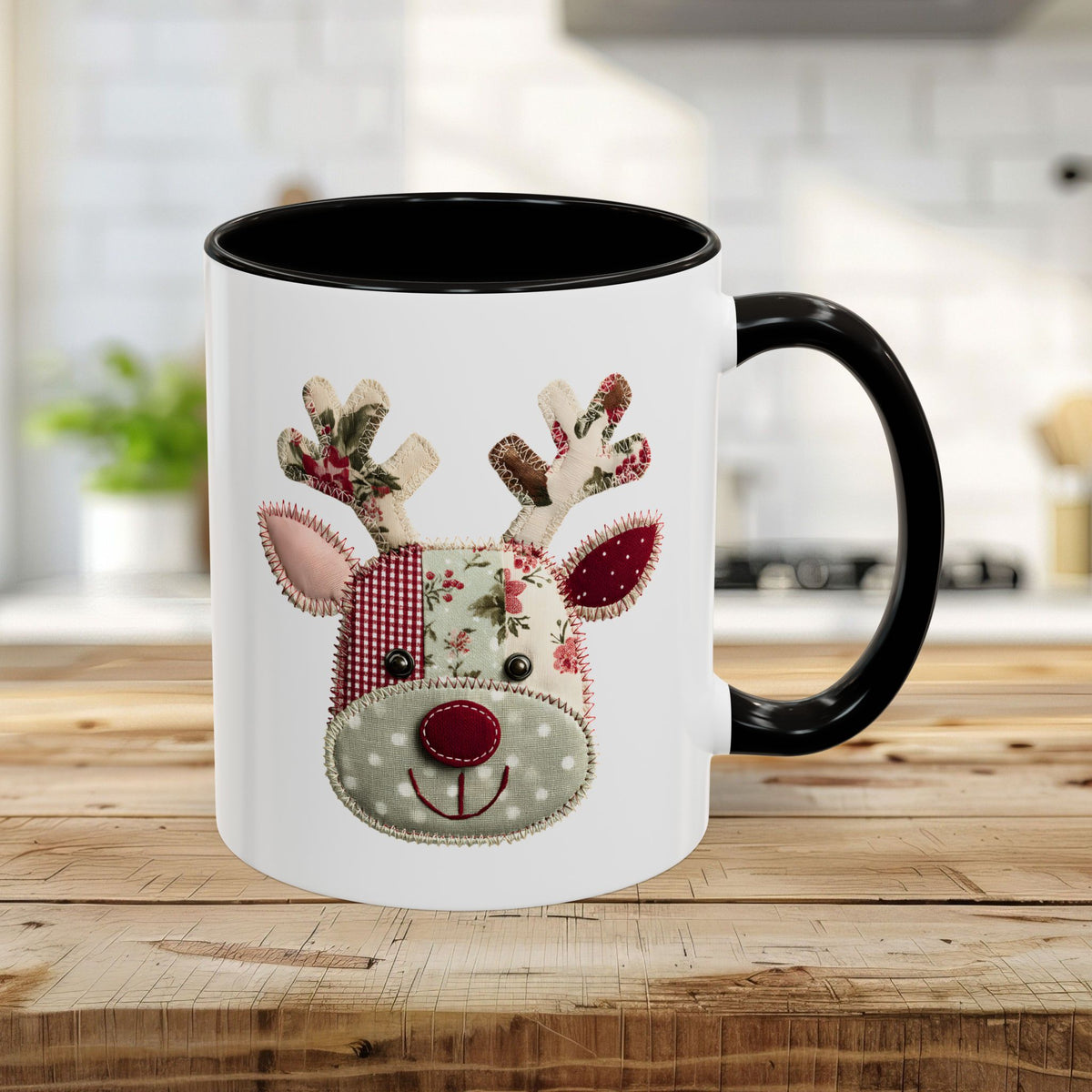 15oz ceramic mug with a patchwork Rudolph design, black handle and interior, on a wooden counter.