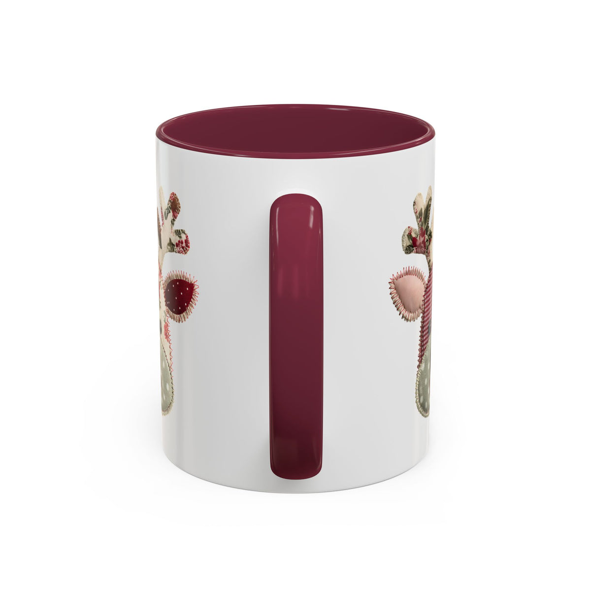 White ceramic mug with a maroon interior and handle, featuring a patchwork Rudolph design.