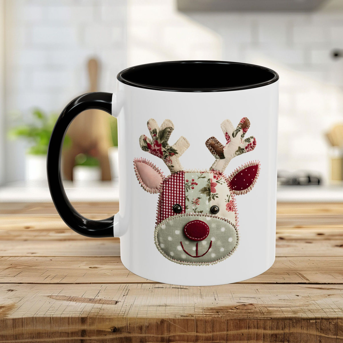White ceramic mug with black handle and interior, featuring a patchwork Rudolph reindeer design.