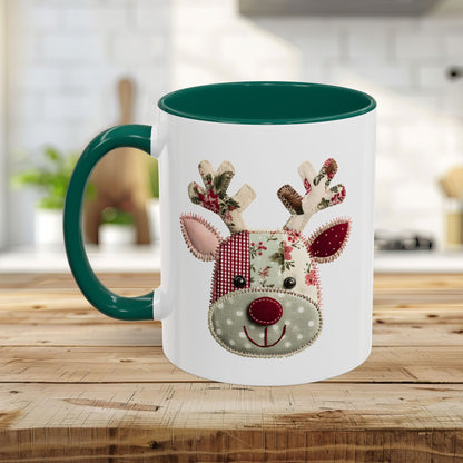 White ceramic mug with green handle and interior, featuring a patchwork Rudolph reindeer design.