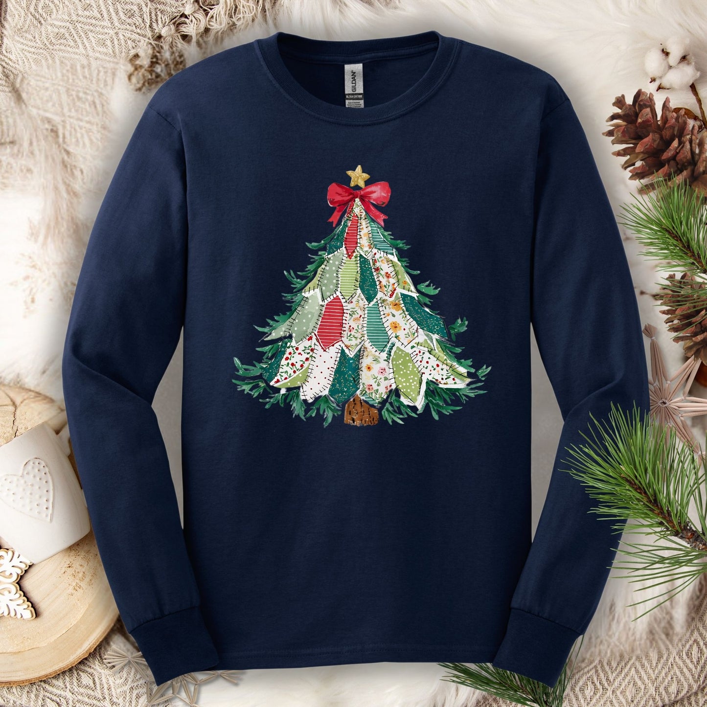 Navy long sleeve tee with a printed country-style quilted Christmas tree design, featuring rustic patterns and warm colors.