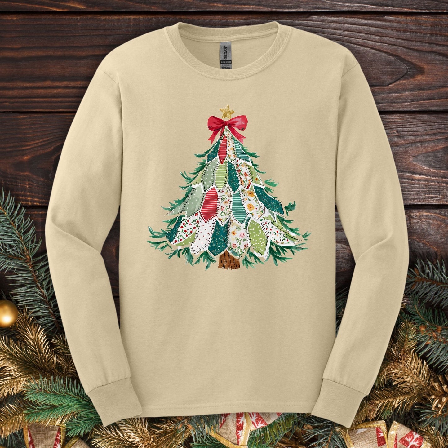 Sand long sleeve tee with a printed country-style quilted Christmas tree design featuring rustic patterns.