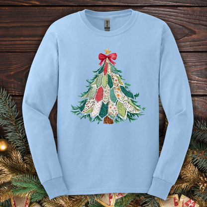 Light blue long sleeve tee with a printed country-style quilted Christmas tree design, red bow, and star.