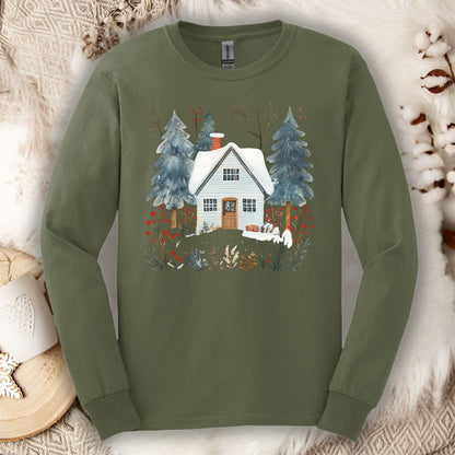 Olive green long-sleeve tee with a hand-drawn winter cabin and pine trees design, on a cozy white faux fur background.