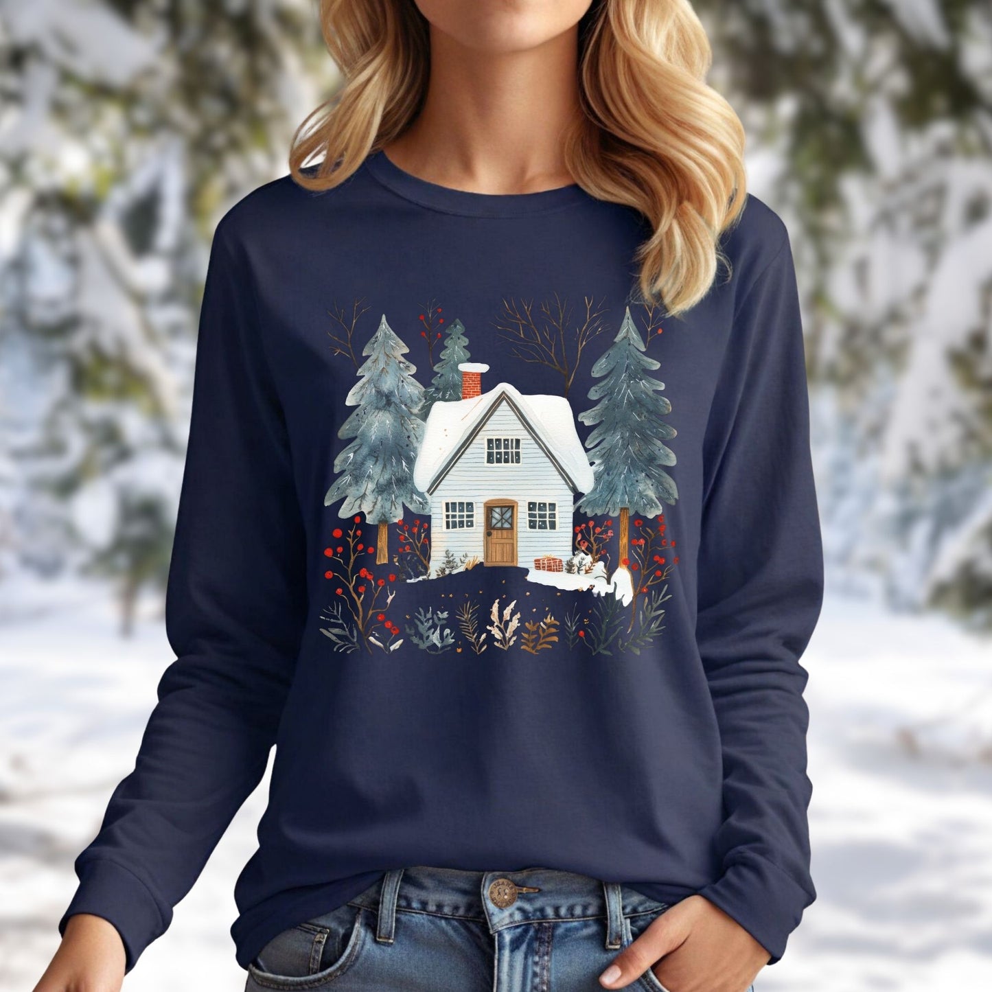 Navy long sleeve tee with a hand-drawn winter cabin and pine trees design, worn by a blonde woman.