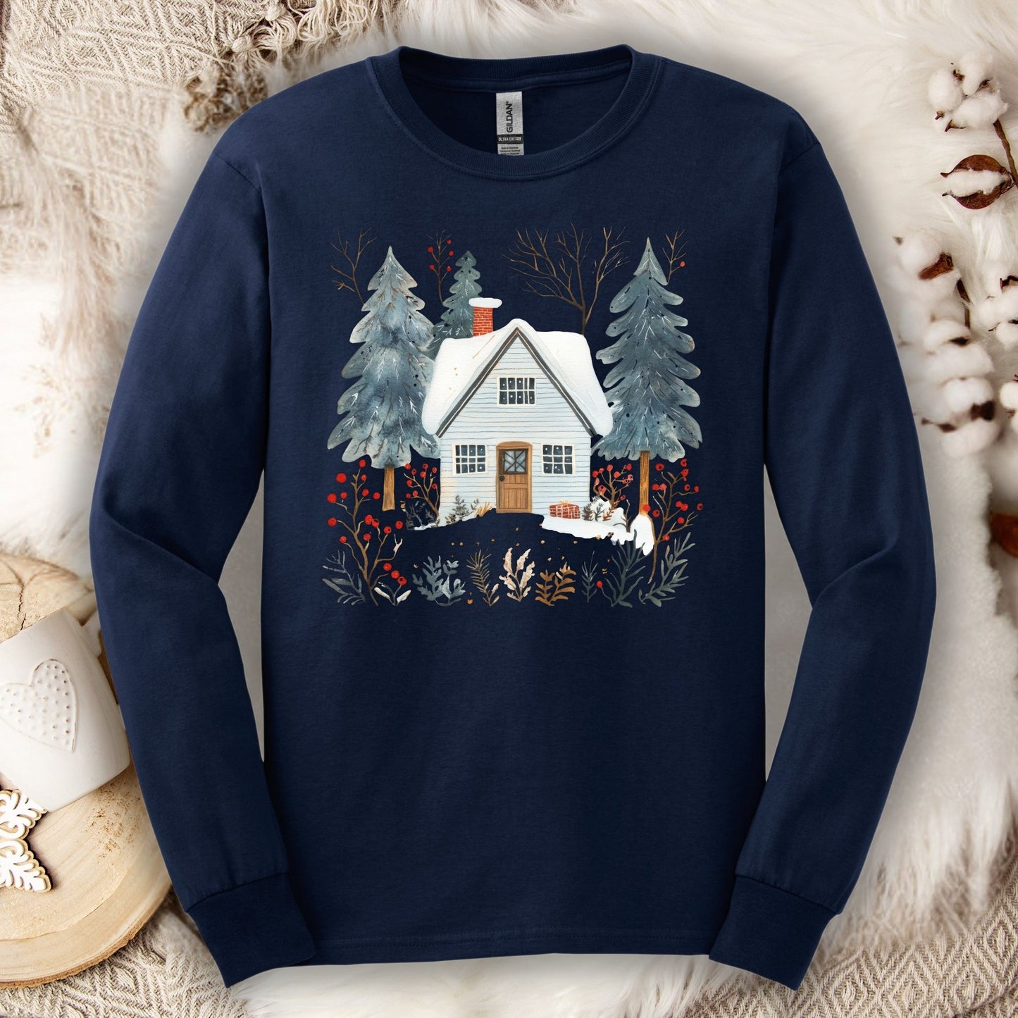 Navy long sleeve tee with a hand-drawn winter cabin and pine trees design, made from soft USA-grown cotton.
