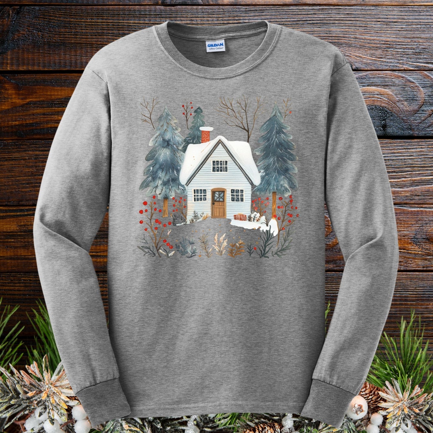 Sport Grey long sleeve tee with a vintage-feel, hand-drawn winter cabin and pine tree design.