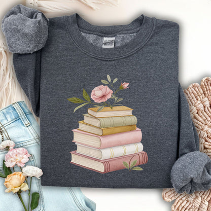 Dark Heather S sweatshirt with a botanical illustration of stacked books and pink flowers.