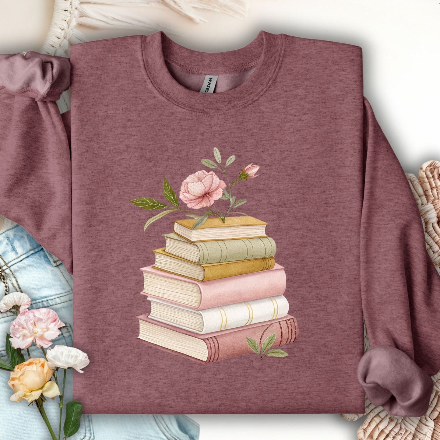 Heather Sport Dark Maroon sweatshirt with botanical art of stacked books and pink flowers.