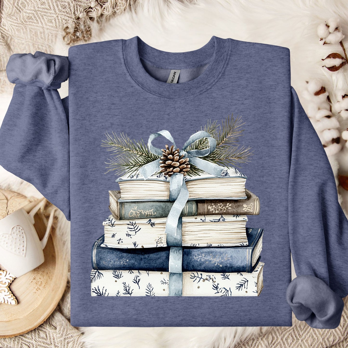Heather Sport Dark Navy sweatshirt with a stack of blue and white books, ribbon, pinecone, and evergreen sprig.