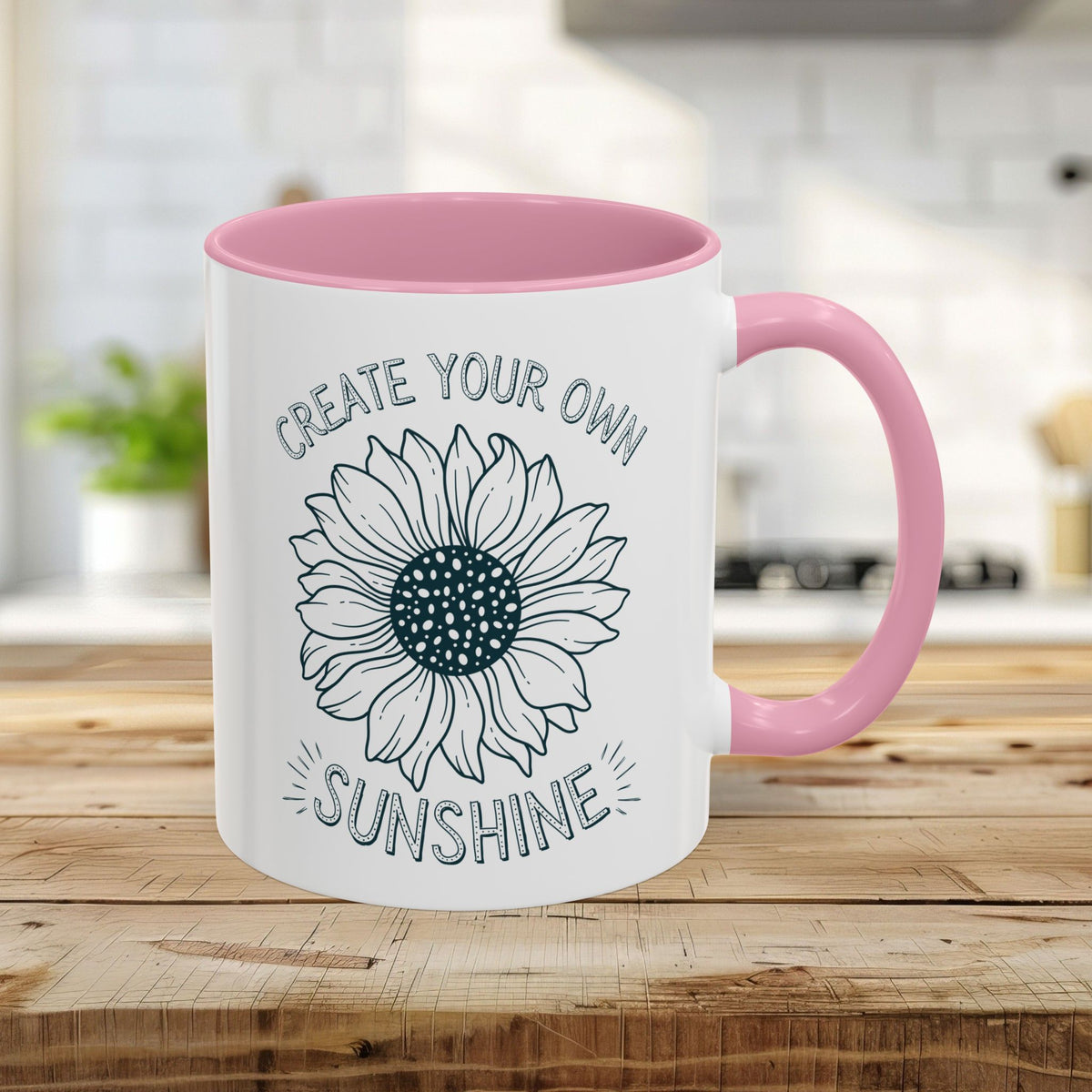 White 11oz ceramic mug with a pink interior and C-handle, featuring a "Create Your Own Sunshine" sunflower design.
