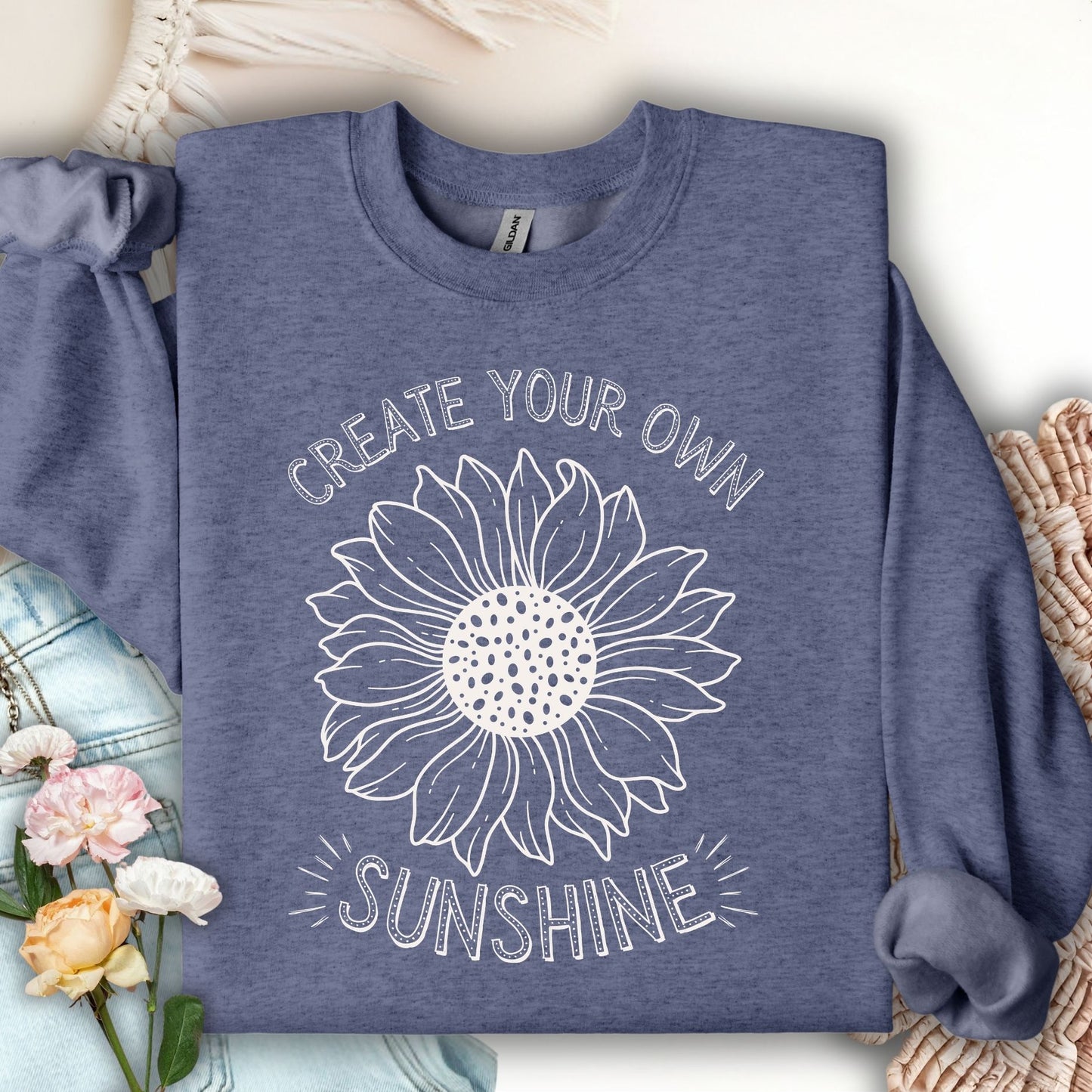 Heather Sport Dark Navy sweatshirt with a white hand-drawn sunflower and "Create Your Own Sunshine" text.