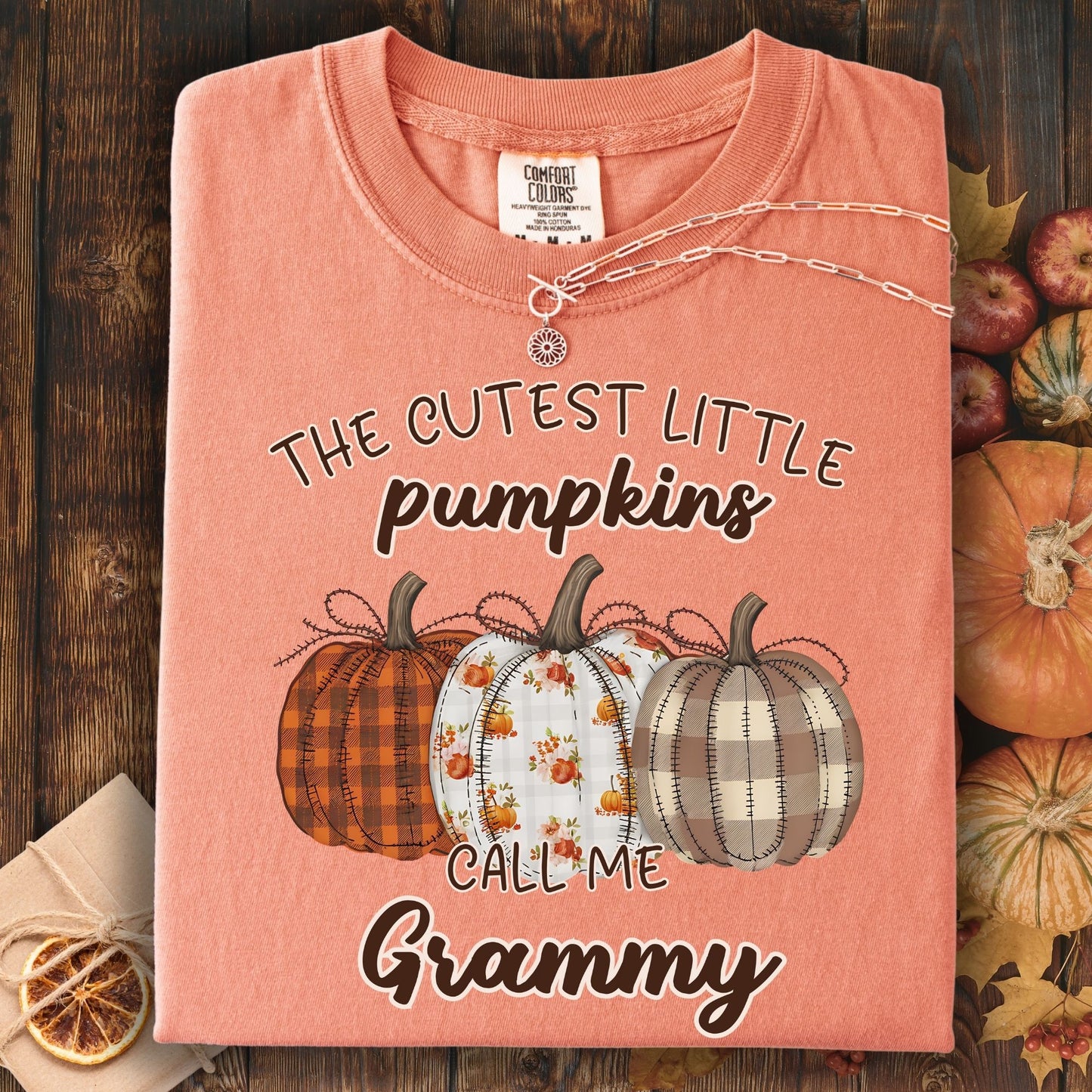 Terracotta Comfort Colors t-shirt with "The Cutest Little Pumpkins Call Me Grammy" and three plaid pumpkins.