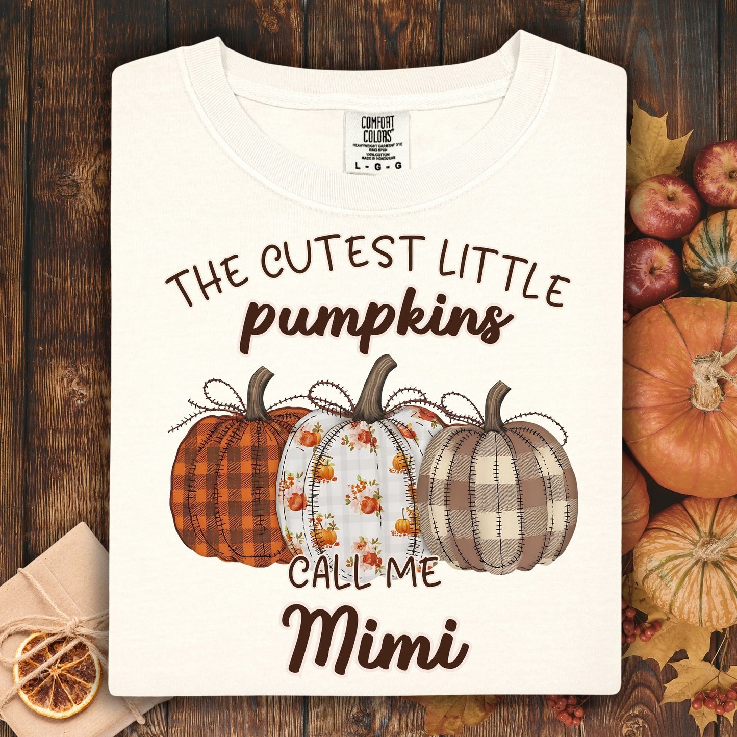 Ivory Comfort Colors t-shirt with "The Cutest Little Pumpkins Call Me Mimi" and three autumn pumpkins.