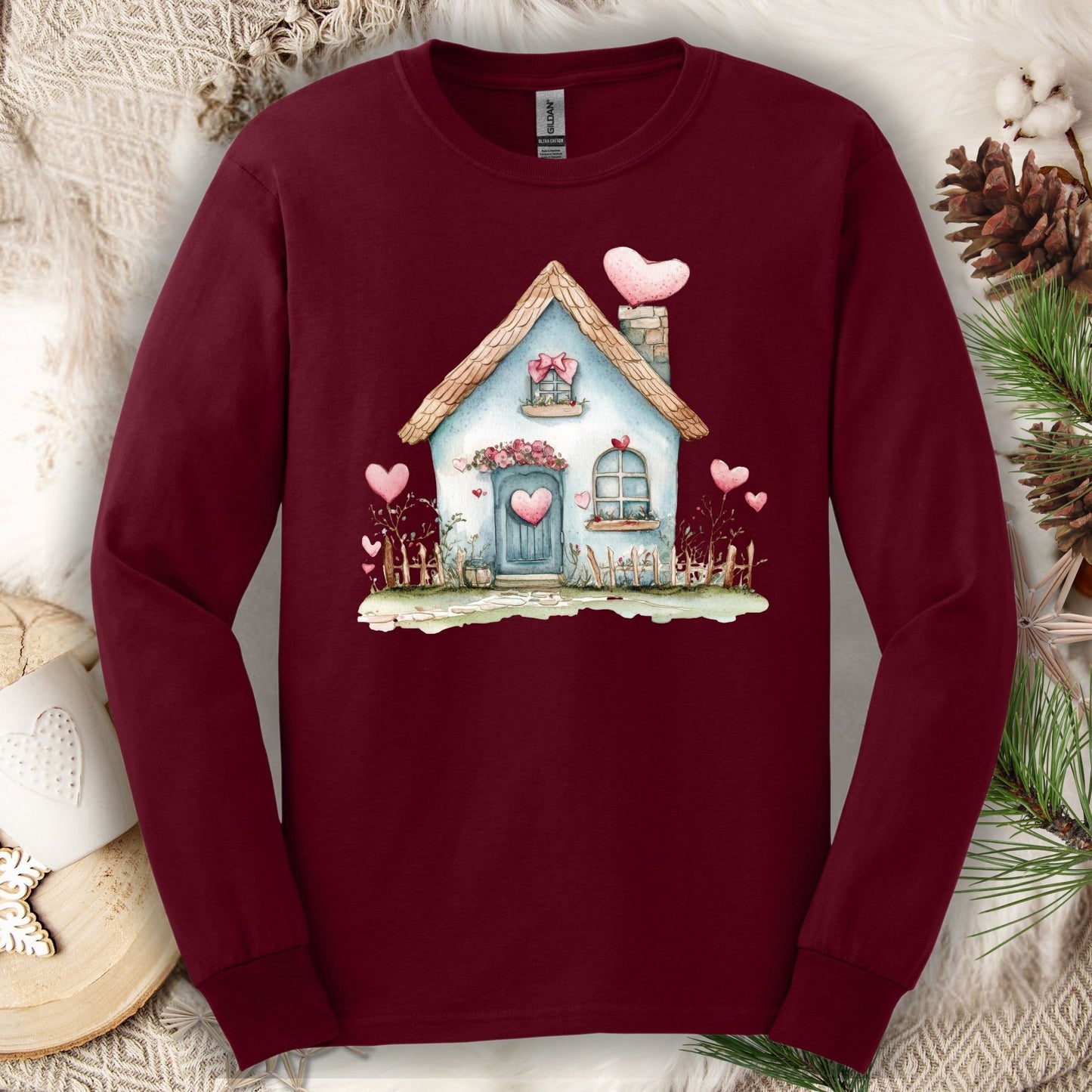 Maroon long sleeve tee with a watercolor blue cottage and pink hearts design.