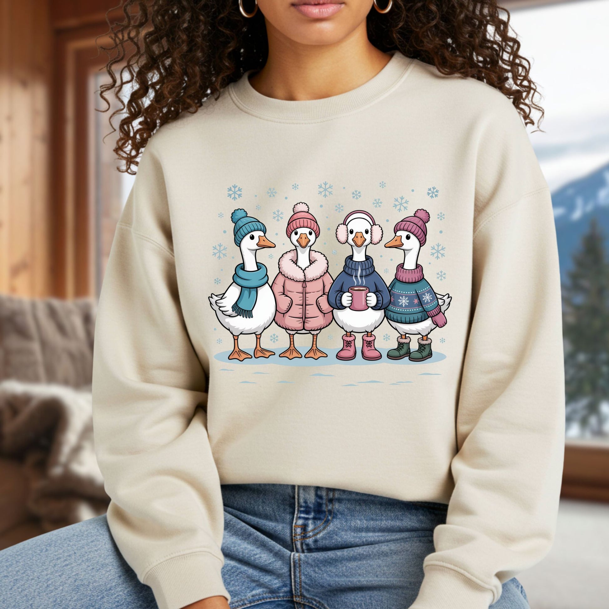 Beige heavy blend sweatshirt with four cartoon geese in winter sweaters, hats, and mittens, drinking hot chocolate.