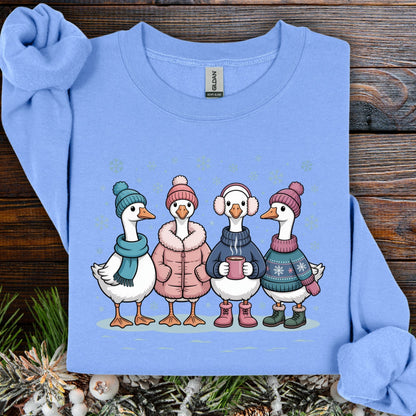 Carolina Blue S sweatshirt with four cute geese in winter sweaters, hats, and mittens, drinking hot chocolate in snow.