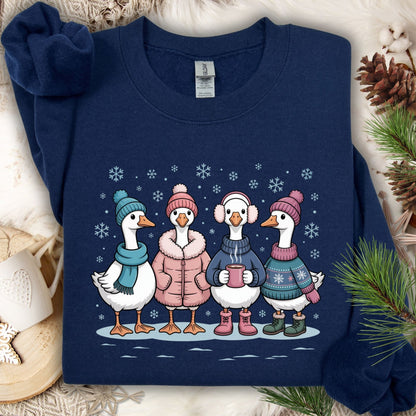 Navy S sweatshirt with four cute geese in winter sweaters, hats, and mittens, drinking hot chocolate in snow.