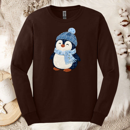 Brown long-sleeve tee with a faux patchwork winter penguin wearing a blue hat and scarf.