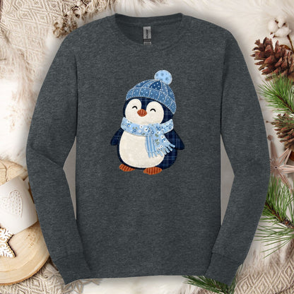 Dark Heather long sleeve tee with a faux patchwork winter penguin in a blue hat and scarf.