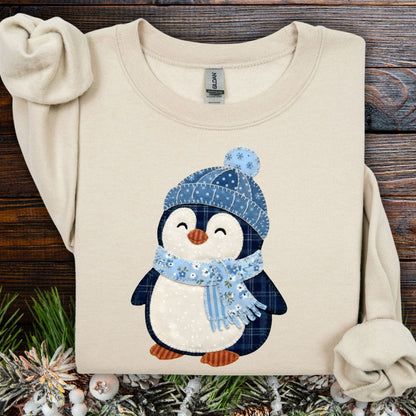 Sand S sweatshirt with faux patchwork penguin in blue hat and scarf.