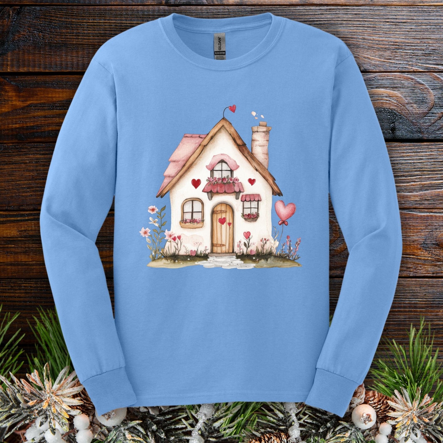 Carolina Blue long sleeve tee with a watercolor beige cottage, pink hearts, and shutters.