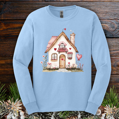 Light blue long sleeve tee with a watercolor beige cottage, pink hearts, and shutters.