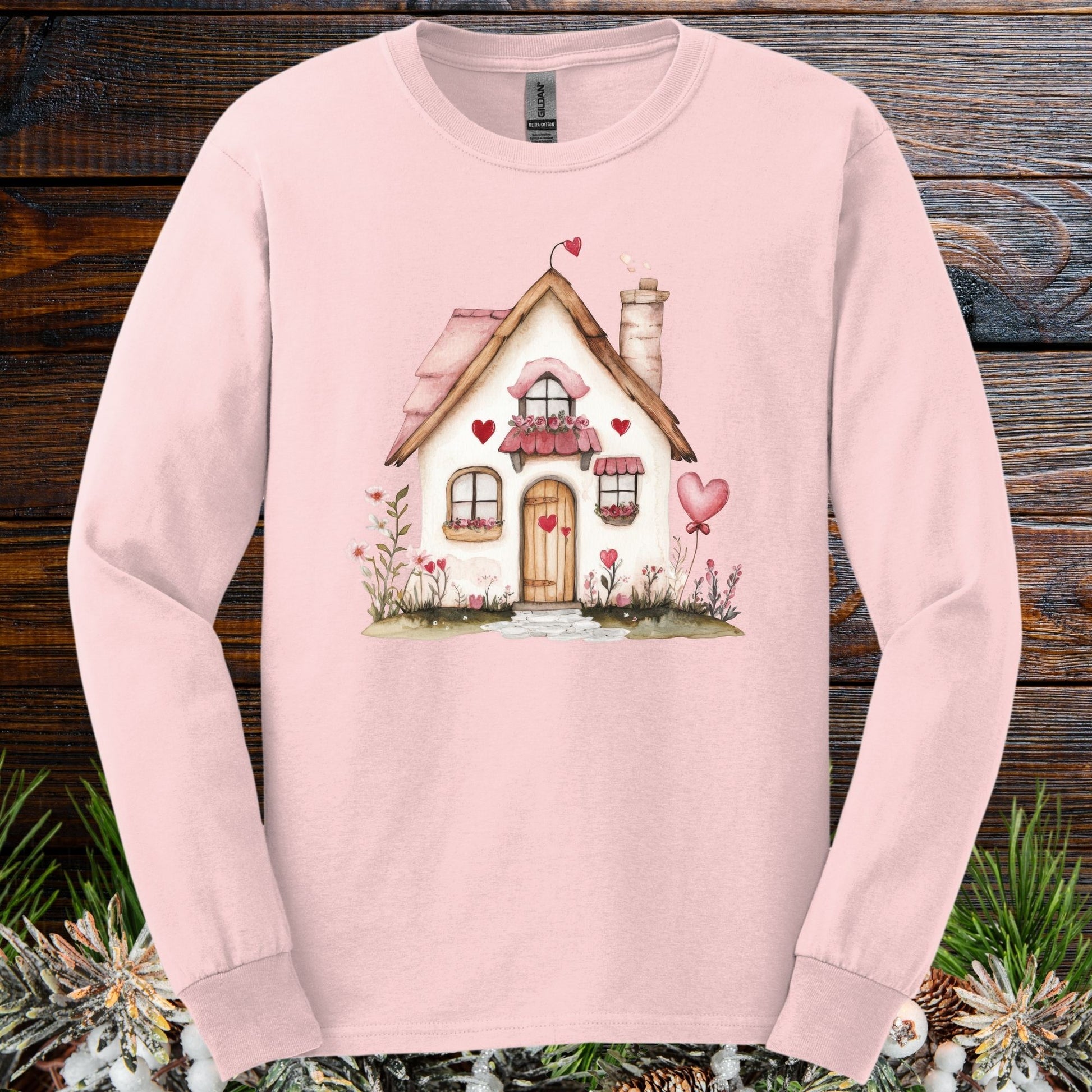 Light pink long sleeve tee with a cute beige cottage, pink hearts, and shutters.