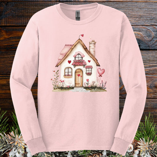 Light pink long sleeve tee with a cute beige cottage, pink hearts, and shutters.