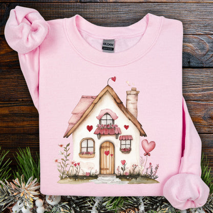 Light pink Gildan sweatshirt with a watercolor pink cottage and hearts design.