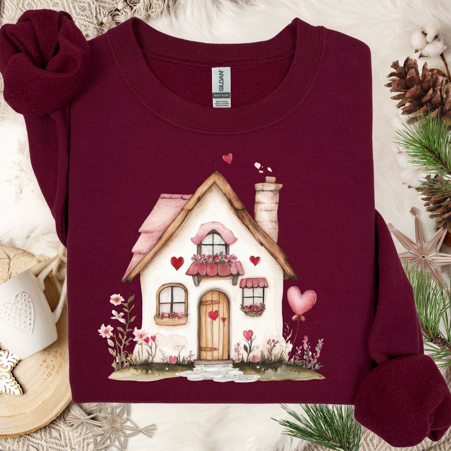 Maroon heavy blend sweatshirt with a watercolor pink Valentine's cottage design, hearts, and floral accents.