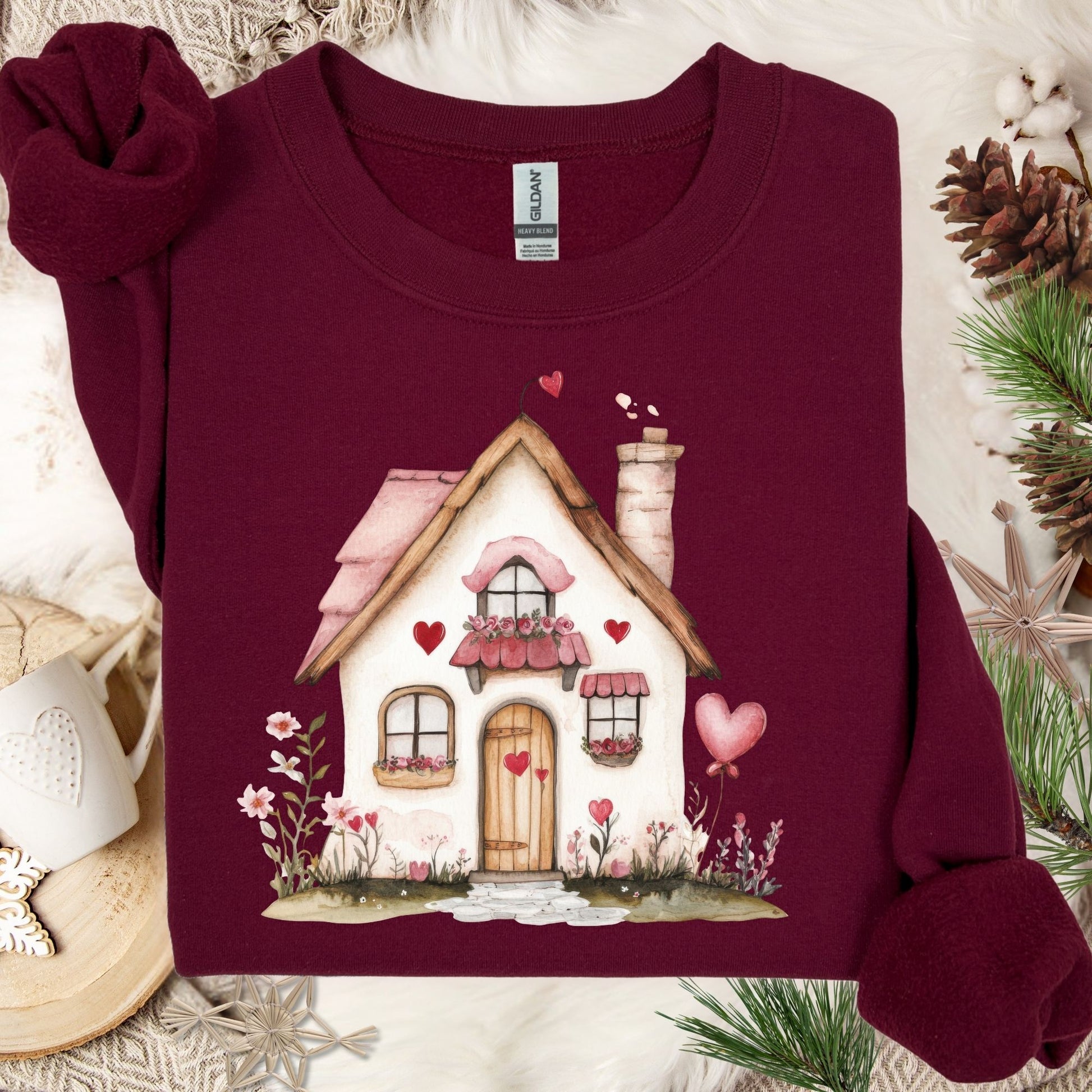 Maroon heavy blend sweatshirt with a watercolor pink Valentine's cottage design, hearts, and floral accents.