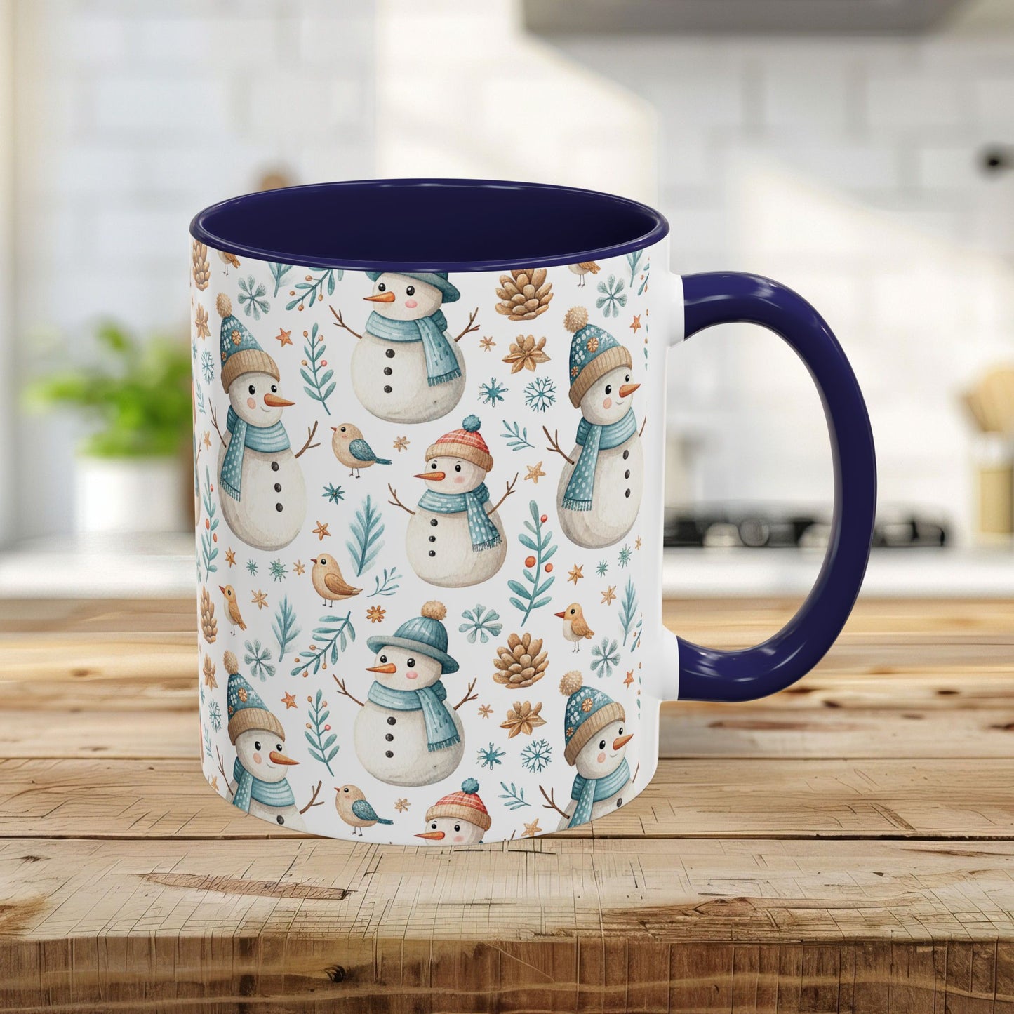 11oz ceramic mug with watercolor snowmen, birds, pinecones, and navy interior/handle.