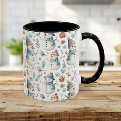 11oz ceramic mug with watercolor snowmen, birds, pinecones, and winter foliage on white, black interior and handle.