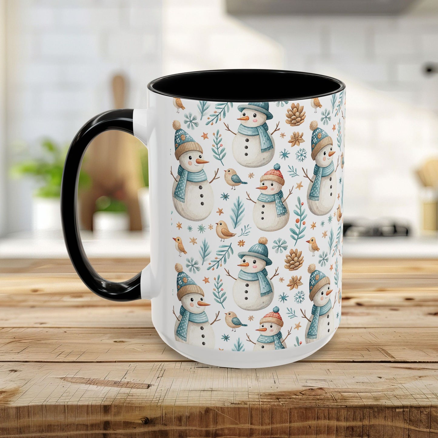 White ceramic mug with black interior/handle, featuring watercolor snowmen, birds, and pinecones.