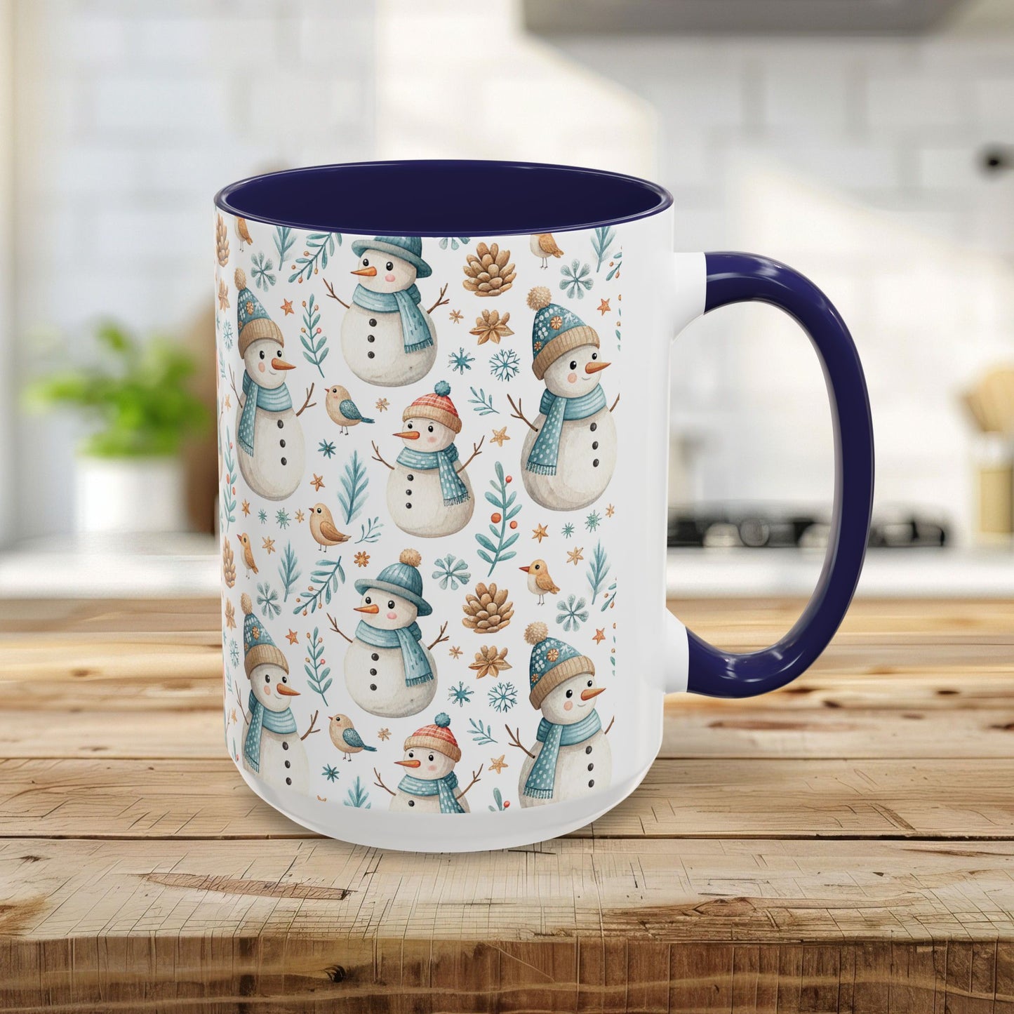 15oz ceramic mug with watercolor snowmen, birds, pinecones, and foliage on white, with a navy interior and handle.