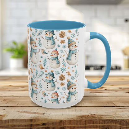 15oz white ceramic mug with light blue handle and interior, featuring watercolor snowmen, birds, and pinecones.