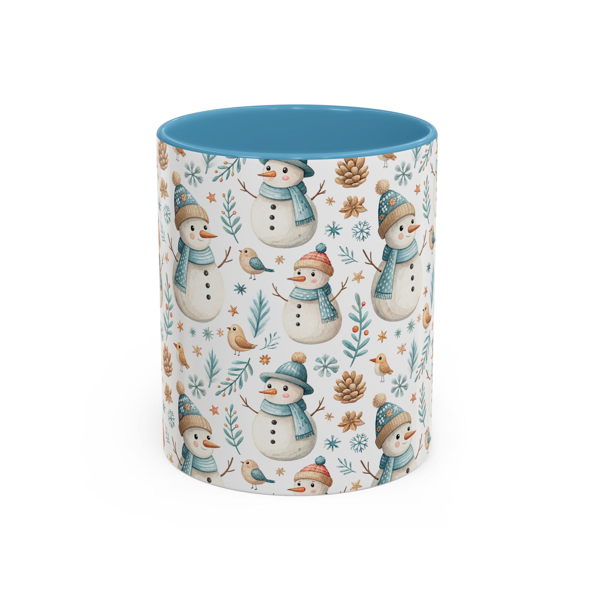 White ceramic mug with watercolor snowmen, birds, pinecones, and snowflakes, featuring a blue interior.
