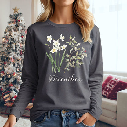 Woman in a charcoal long sleeve tee with watercolor narcissus and holly berry design, "December" script.