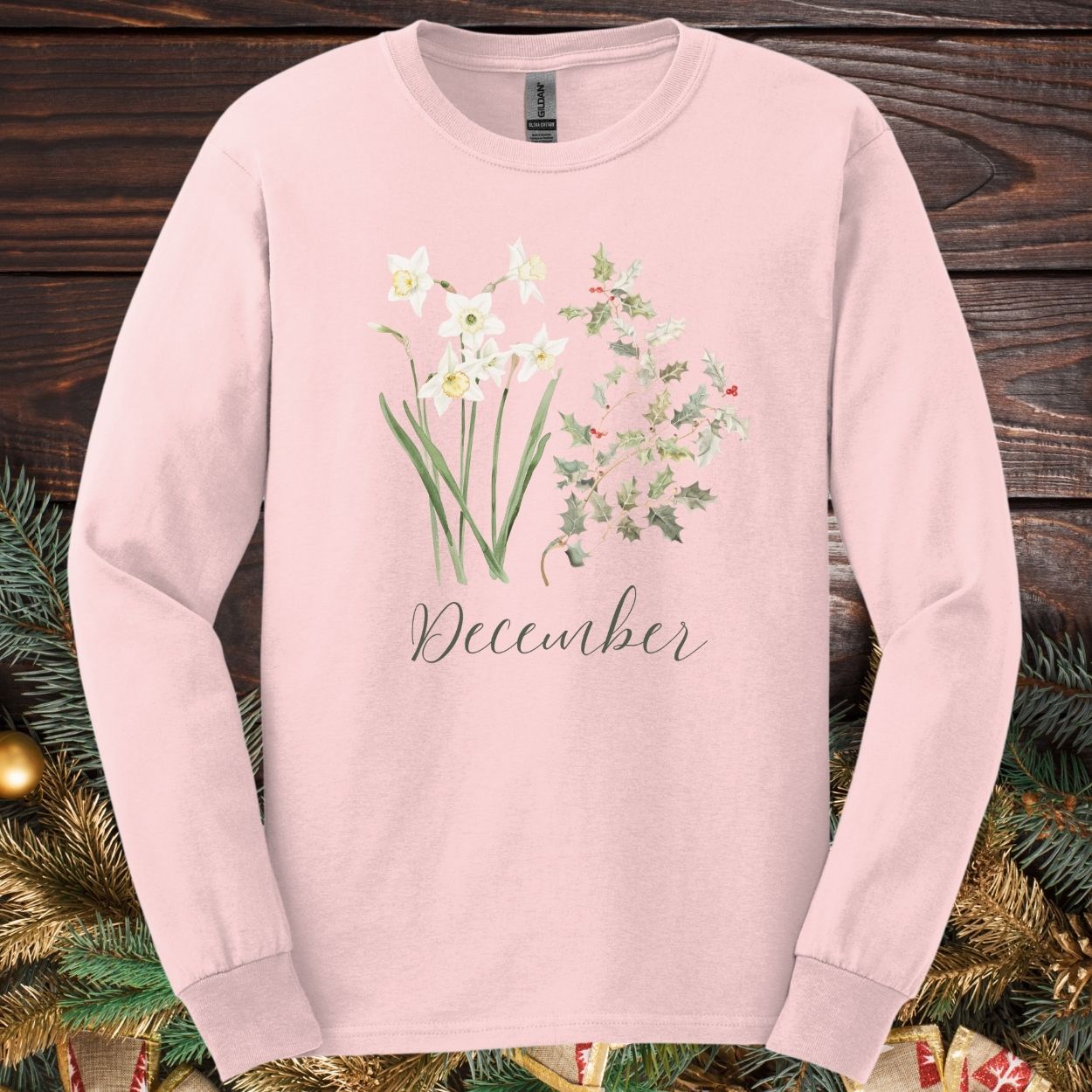 Light pink long sleeve tee with watercolor narcissus, holly, and "December" script.